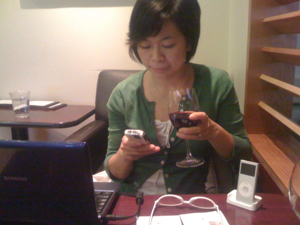 {A photo of me at a DC airport wine bar en route to Switzerland for vacation in 2009, with my Blackberry, netbook & iPod.}